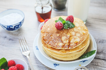 breakfast table stacked pancakes raspberries mint sugar milk