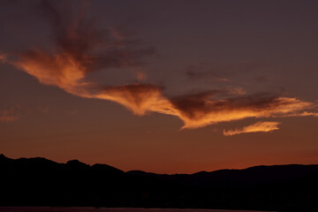 Beautiful peach clouds over the sea and mountain