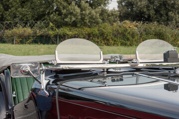 front of old convertible car perspective view with green background