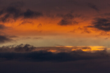 Fototapeta na wymiar The sky before a thunderstorm. Incredibly beautiful orange sunset.