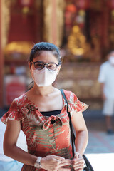 young Asian girl wearing Protective face mask protect coronavirus inflection, Happy tourist woman...