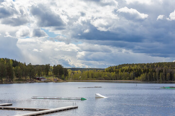 Dark clouds before the storm over a lake in Sweden. Thunderclouds in the sky before the rain.