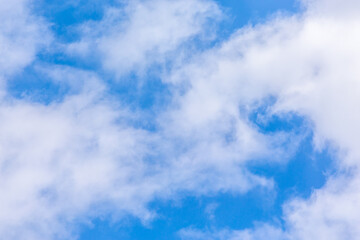 fluffy white clouds against a blue sky