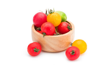 Naklejka na ściany i meble Colorful tomatoes, Japanese sweet tomato in the wooden cup isolated on white background with clipping path.