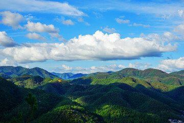 Fototapeta premium Landscape of the green mountains near Kyoto with sun and beautiful clouds, Japan