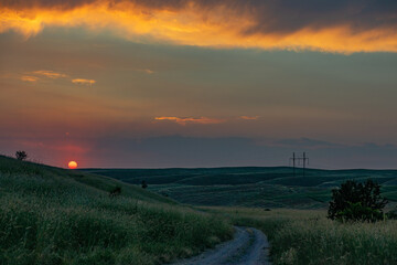 Fototapeta na wymiar Sunset in the field with beautiful sky