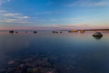 Baltic sea coast with stones and a beautiful sunset, long exposure photograph as a background for a postcard