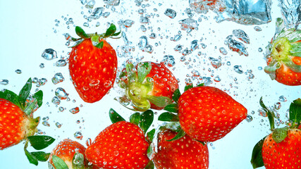 Freeze Motion Shot of Fresh Strawberries Falling Into Water Isolated on White Background.