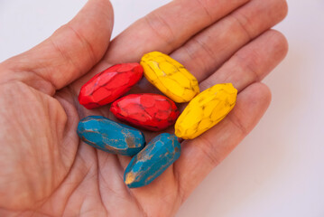 Handmade colorful beads of polymer clay in woman hand.