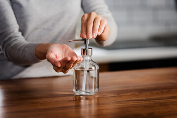 Closeup of woman hands using hand sanitizer liquid for bacteria and virus neutralization. Keep your hands germ-free and virus free with the use of hand sanitizer. Personal Protective Equipment for Inf
