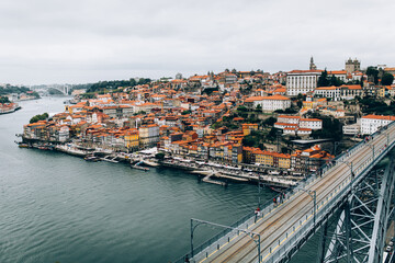Fototapeta na wymiar view from the bridge of the old town Porto river and houses with red tiled roofs