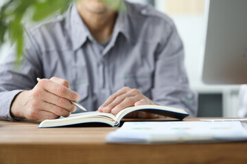 Close up of serious man that making notes