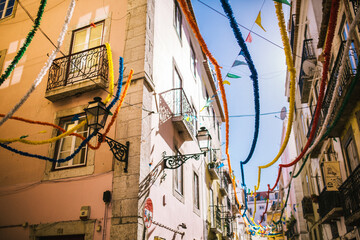 Fototapeta na wymiar old houses decorated with colored holiday ribbons for the carnival