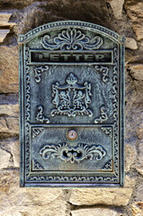 Metal mailbox on stone wall