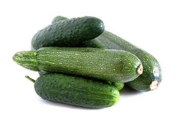 Cucumbers and zucchini on a white background. Suitable for mockups and backgrounds. Food preparation. Vegetables.