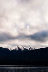 photo of a overcast sky and a mountain range of peaks