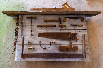 Old work tools on a board