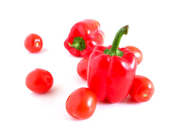 Red sweet peppers and tomatoes on a white background. Suitable for mockups and backgrounds. Food preparation. Vegetables.
