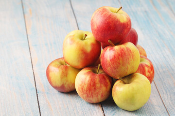 Several ripe red apples on the wooden table