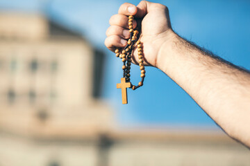 man holds a cross on his hand