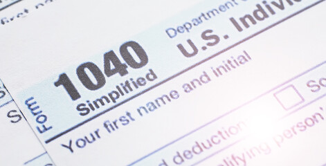 Annual tax reporting. Tax form on the table. Financial statements for signature.