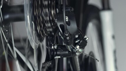 Work of chain drive, rear derailleur with cassette. Changing speeds, gearshift on mountain bike MTB. Chain moves on cogset cogs. Jockey wheels, idler lower and upper pulley. Shift gears. Macro shot