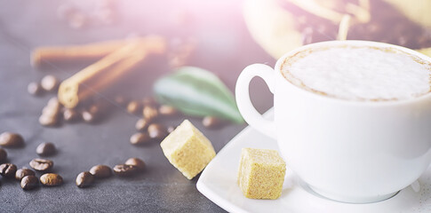 Coffee beans with green leaves for cooking. Bag of coffee. Coffee beans roasted on the table.