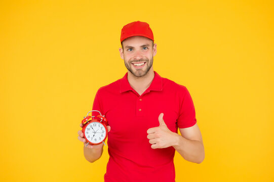Promptness and punctuality. Delivery time. Delivery courier with clock. Delivery man holding clock. Shipping services. Post office. Online shopping. Will deliver at agreed time. Timeliness guarantee