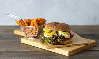 Veggie halloumi burger with kiwi and sweet potatoes. Copy space