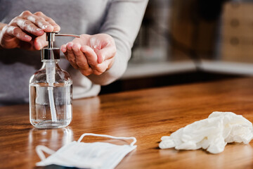 Closeup of woman hands using hand sanitizer liquid for bacteria and virus neutralization. Keep your hands germ-free and virus free with the use of hand sanitizer. Personal Protective Equipment for Inf