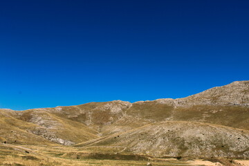 Mountain landscape, karst hill with a lot of stones and grass without other plants. Bjelasnica Mountain in autumn, Bosnia and Herzegovina.