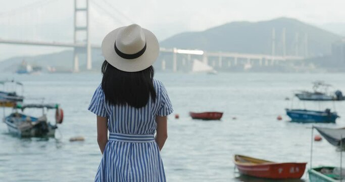 Travel woman enjoy sea view in city