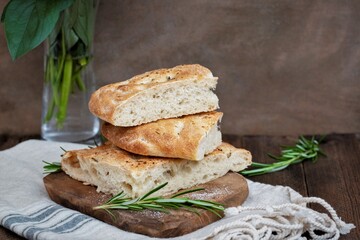 Sliced focaccia sour dough bread, dark background