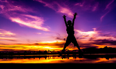 Amazing sunset and sunrise.Dark tree on open field dramatic sunrise.Panorama.Countryside Landscape Under Scenic Colorful Sky At Sunset Dawn.With the silhouette of the boy.