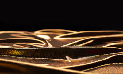 Gold fabric waves on a black background