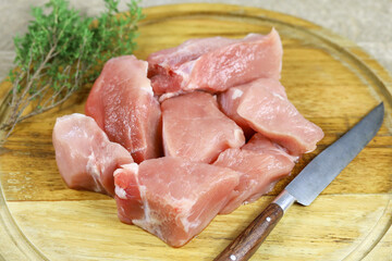 morceaux de porc cru sur une planche à découper