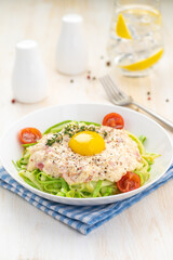 Traditional dish of Italian cuisine carbonara sauce with low-carb zucchini paste and egg yolk.