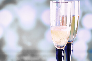 Background with tall glasses for sparkling wines. Champagne and spray in glass glasses. Celebratory drink with reflection.