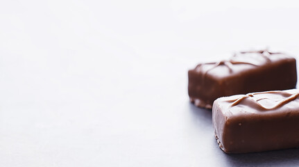 Chocolate bars on a black background in backlight. Chocolate with filling. Sweet sweets for snack and tea.