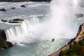 View of the Horsehoe Falls at Niagara Falls enveloped in mist.