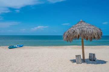 Two Chairs Under Parasol In Tropical Beach