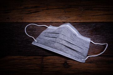  The surgical mask with covid 19 spread around the world. Impact of pandemic virus infection which represents a gloomy atmosphere