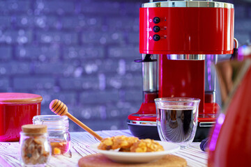 Red coffee machine with a glass on kitchen counter