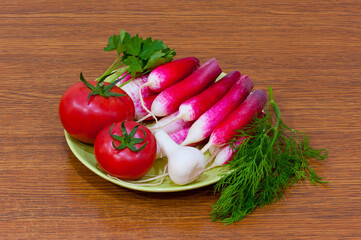 Vegetables for salad - radishes, tomatoes, garlic and herbs.