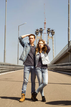 Two young people man and woman wearing jeans outdoors. Fashion concept with beautiful couple.