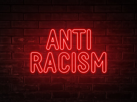 Anti-racism - red neon light word on brick wall background