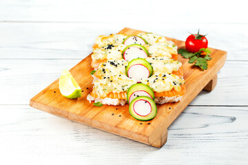 Baked salmon fish fillet with sause and vegetable on wooden plate.