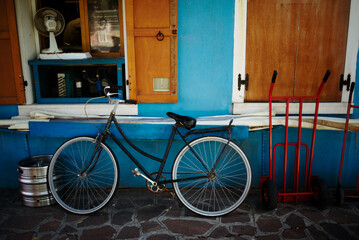 The colorful houses of Burano. Bicycle at home on the island of Murano, Venice. Italy.