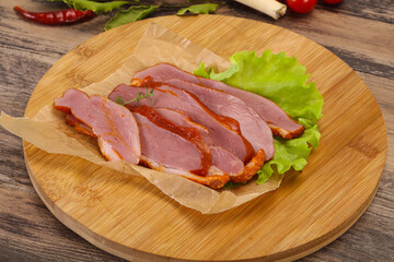 Sliced smoked duck breast served salad