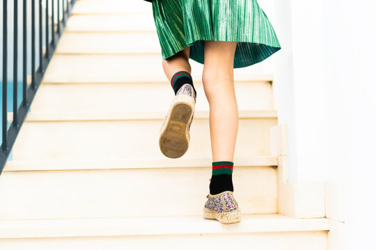 Girl Wearing Green Skirt Running Upstairs